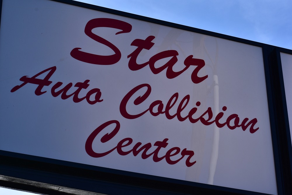 A sign that says Star Auto Collision Center